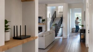 Home interior with router in foreground and user farther away through rooms, with no visible text or logos.